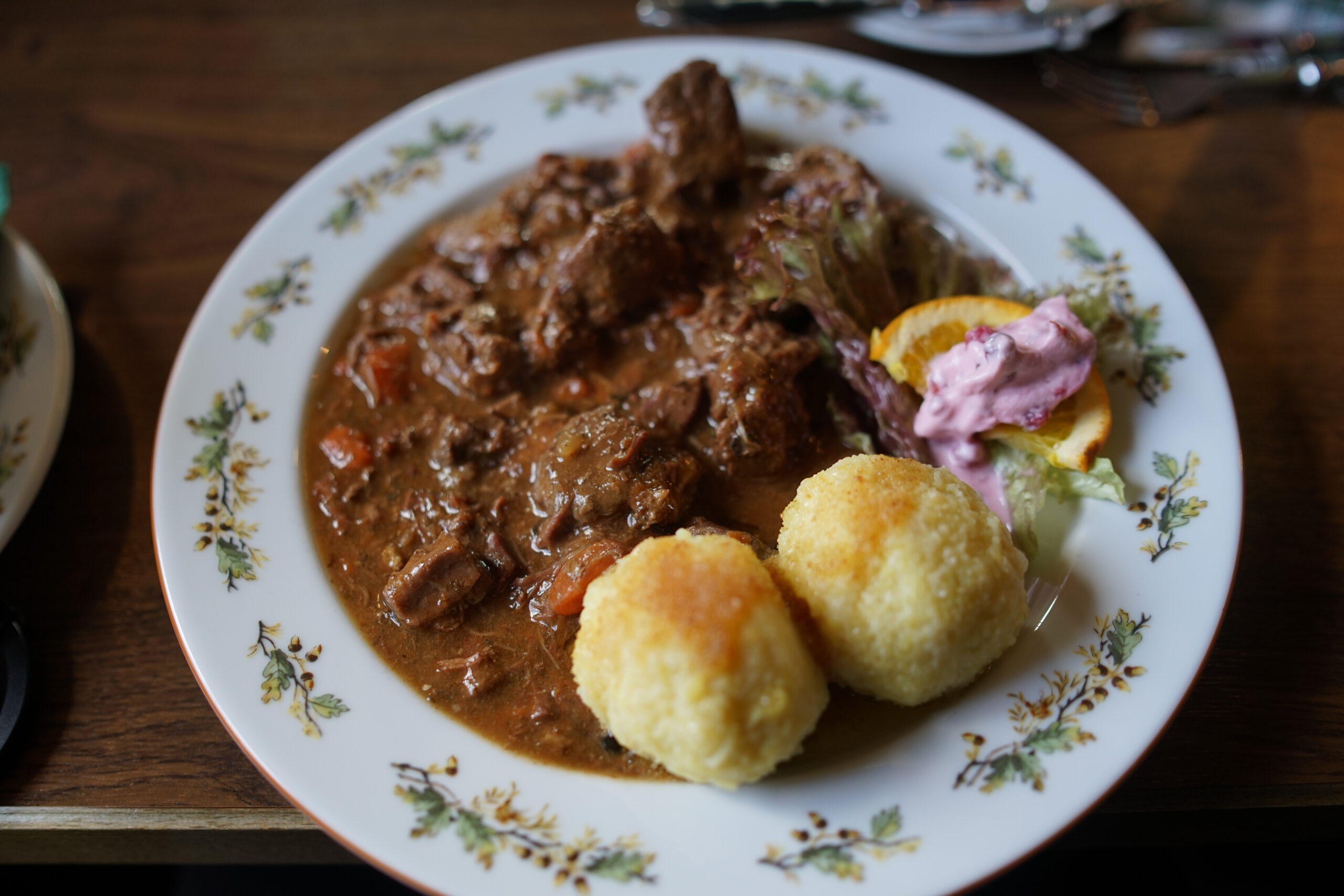 Traditional game goulash with dumplings at german game restaurant